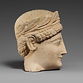Limestone head of a beardless male votary with a wreath of leaves, Limestone, Cypriot