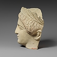 Limestone head of a beardless male votary with a wreath of leaves, Limestone, Cypriot