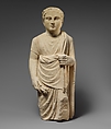 Limestone statuette of a boy holding a pyxis and a branch of leaves, Limestone, Cypriot
