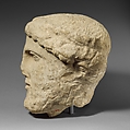 Limestone head of a bearded male with a wreath of leaves, Limestone, Cypriot