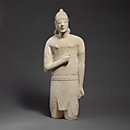 Limestone statuette of a beardless male votary in Egyptianizing dress wearing a helmet, Limestone, Cypriot