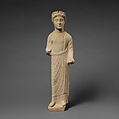 Limestone statuette of a beardless male votary with a wreath of leaves, Limestone, Cypriot