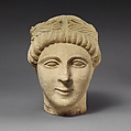 Limestone head of a beardless male votary with a wreath of leaves, Limestone, Cypriot