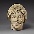 Limestone beardless male head with a wreath of rosettes, Limestone, Cypriot