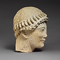 Limestone head of a beardless male with a wreath of flower buds, Limestone, Cypriot