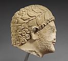 Limestone head of a bearded male with a wreath of leaves, Limestone, Cypriot