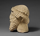 Limestone head of a bearded male with a wreath of leaves, Limestone, Cypriot