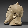 Limestone head of a bearded male wearing a conical helmet, Limestone, Cypriot