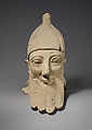 Over-lifesize bearded head wearing a conical helmet, Limestone, Cypriot
