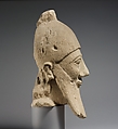 Over-lifesize bearded head wearing a conical helmet, Limestone, Cypriot
