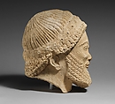 Limestone head of a bearded male with a wreath of flowers, Limestone, Cypriot