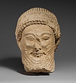 Limestone head of a bearded male with a wreath of flowers, Limestone, Cypriot