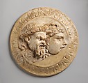 Marble disk with two theater masks in relief, Marble, Roman