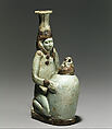 Faience double-spouted vessel in the form of a kneeling woman holding a jar, Faience, East Greek