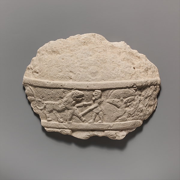 Fragment of a limestone statue of a male votary (worshipper)