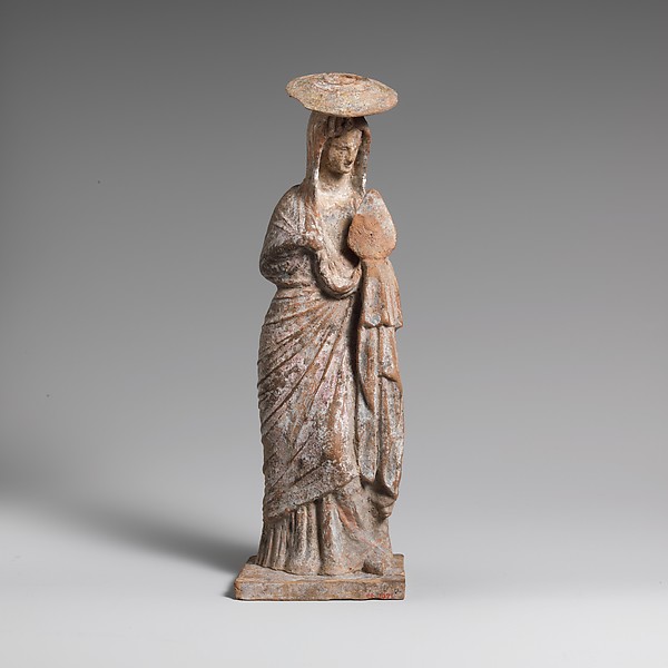 Terracotta statuette of a woman wearing a hat and holding a fan by an unrecorded maker, The Metropolitan Museum of Art