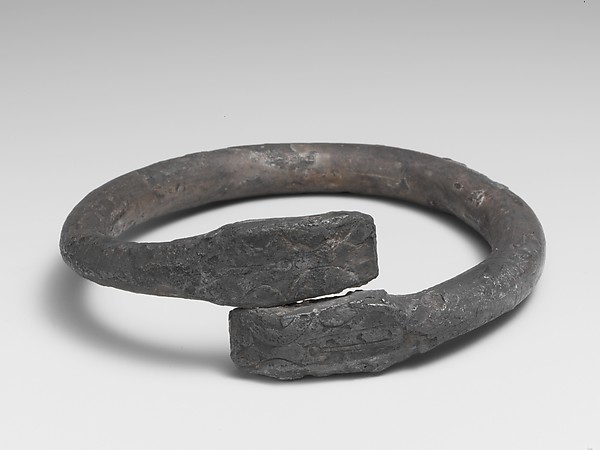 Silver bracelet ending in snake's heads