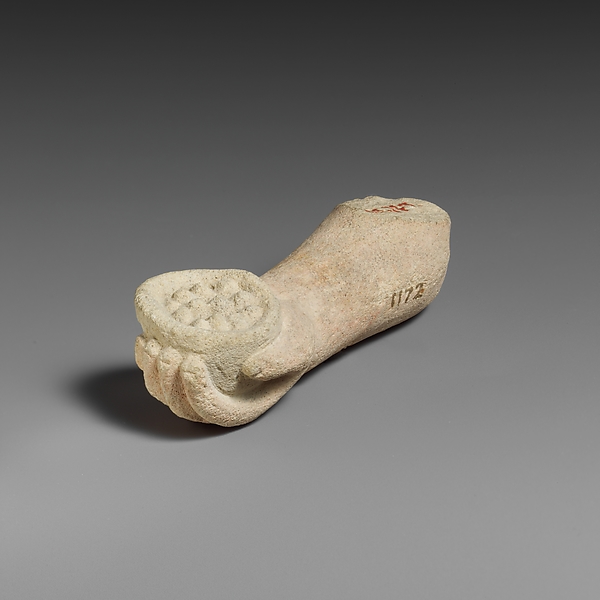 Limestone arm with pieces of fruit (?) held in the hand by an unrecorded maker, The Metropolitan Museum of Art