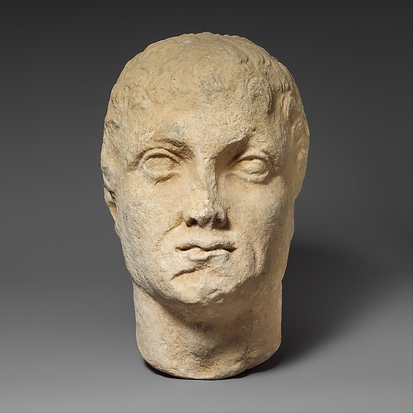 Limestone head of a beardless male votary