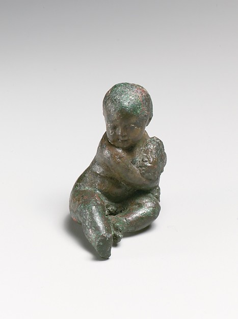 Bronze statuette of a child with a bunch of grapes