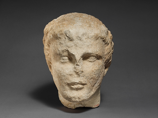 Limestone head of a bearded male votary
