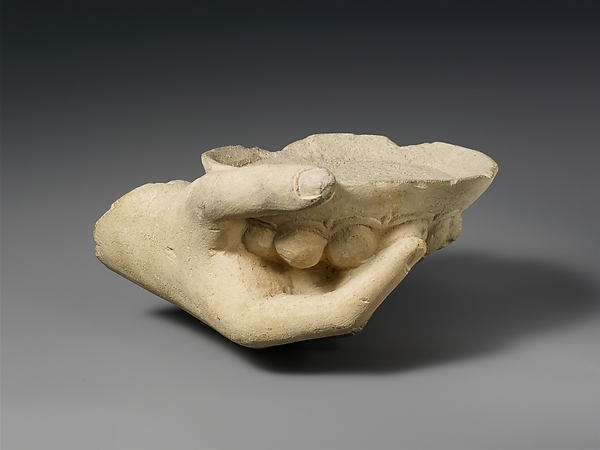 Limestone statue fragment of a right hand holding a phiale (libation bowl) by an unrecorded maker, The Metropolitan Museum of Art