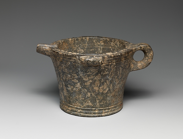 Serpentine bowl with spout and handle