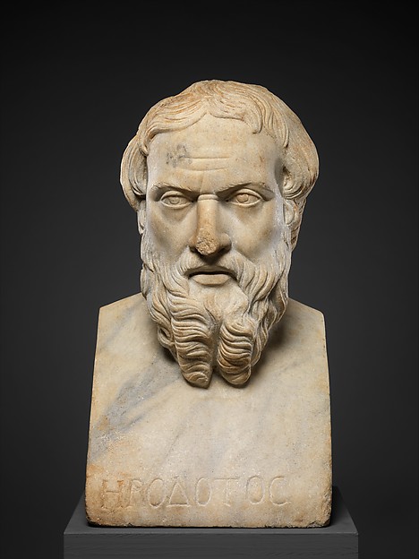 Roman marble bust of the historian Herodotos, bearded, his name cut in Greek across the base, photographed in low light on a dark ground