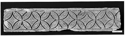 Fragment from a Post or Lintel with Leaves Branching from a Running Vine
, Limestone; carved in relief