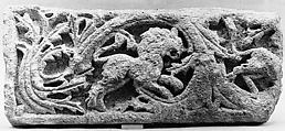 Fragment of a Frieze with Scrolls and a Lion, Limestone; carved in relief