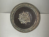 Bowl with Knotted Medallion, Earthenware; black slip with white slip decoration under transparent glaze