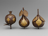 Three Qajar Gold-Damascened Steel Fruits, Steel; damascened with gold