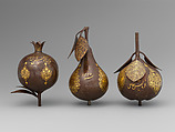 Three Qajar Gold-Damascened Steel Fruits, Steel; damascened with gold