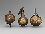 Three Qajar Gold-Damascened Steel Fruits, Steel; damascened with gold