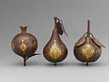 Three Qajar Gold-Damascened Steel Fruits, Steel; damascened with gold