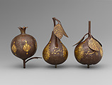 Three Qajar Gold-Damascened Steel Fruits, Steel; damascened with gold
