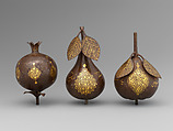 Three Qajar Gold-Damascened Steel Fruits, Steel; damascened with gold