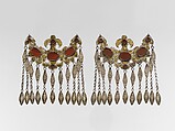 Headdress Ornament, Silver with gilt applique decoration, connecting links with embossed decoration, rams head terminations, silver link chains, and table cut carnelians