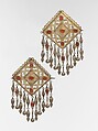 Pair of Pectoral Ornaments, Silver; fire gilded and engraved/punched with openwork, perforated upper terminations, twisted silver wire chains and pendants with appliques, and table-cut carnelians