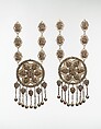 Pair of Pectoral Ornaments, Silver; with false granulation stamped and bead decoration, glass or colored stones, silver link chains, and bells/beads