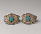 Armband, One of a Pair, Silver; with decorative wire whorl decoration, silver shot, table-cut
turquoises, and turquoise and coral beads