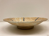 Plate, Earthenware; white slip under transparent greenish glaze