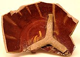 Waster of a Bowl with a Tripod Stuck Inside, Earthenware; gritty buff body, reddish brown and yellow streak decoration
