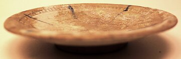 Dish, Stonepaste; colorless, iridescent glaze; gritty, white,body; restored.