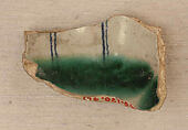 Ceramic Fragment, Earthenware; opaque white glaze, green splashed glaze, inscription in blue