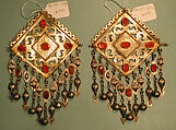 Pair of Pectoral Ornaments, Silver; fire gilded and engraved/punched with openwork, perforated upper terminations, twisted silver wire chains and pendants with appliques, and table-cut carnelians