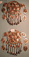Pair of Pectoral Ornaments, Silver; with false granulation stamped and bead decoration, glass or colored stones, silver link chains, and bells/beads