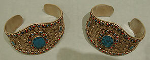 Armband, One of a Pair, Silver; with decorative wire whorl decoration, silver shot, table-cut
turquoises, and turquoise and coral beads