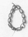 Li-Ba-Li-Ba-Ba (acorn lipper), Acorns, fiber cord, wood, Native American (Yukian)
