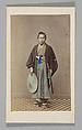 [Japanese Naval Officer]
[Studio Portrait: Japanese Man (Tateise Onogero) Standing Holding Hat and Sword], Attributed to Felice Beato (British (born Italy), Venice 1832–1909 Luxor), Albumen silver print with applied color